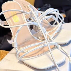 White strap up block heels.